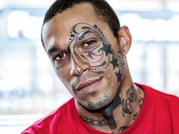 Italian Pop Star With Knife Tattoo On His Face - Tattoo Ideas and Designs |  Tattoos.ai