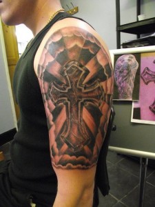 Tribal and Cross Half Sleeve Tattoos